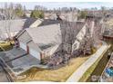An elevated aerial view of a single Gathering home with an attached two car garage at 1333 Charles Dr # 15, Longmont, CO 80503