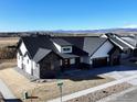 Desirable single-Gathering home with a two-car garage, beautiful stone accents, and a red front door at 1347 Burt Ave, Berthoud, CO 80513