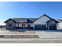 Charming single-Gathering home featuring stone accents, a red front door, and a two-car garage at 1347 Burt Ave, Berthoud, CO 80513