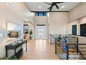 Spacious foyer boasts soaring ceilings, elegant lighting, and beautiful hardwood floors at 1347 Burt Ave, Berthoud, CO 80513