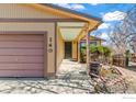 Inviting covered front porch with garden area leads to the main entrance at 140 Judson St, Longmont, CO 80501