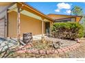 Charming covered porch with a small garden area leads to the front door at 140 Judson St, Longmont, CO 80501