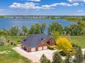 Aerial shot showcasing a beautiful house near the lake and large three-car garage at 2366 Shoreside Dr, Berthoud, CO 80513