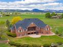 Beautiful brick home with manicured lawn and backyard with amazing mountain views at 2366 Shoreside Dr, Berthoud, CO 80513