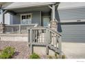 Inviting front porch with stone accents and sturdy railing leading up to the main entrance of the house at 2723 Crystal Springs, Longmont, CO 80503