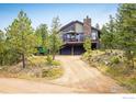 Exterior view of beautiful home featuring large windows and a spacious balcony with views of the surrounding landscape at 302 Deer Trail Cir, Boulder, CO 80302