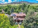 Gorgeous aerial view showcasing a home with solar panels, lush greenery, and mountain views at 3135 11Th St, Boulder, CO 80304