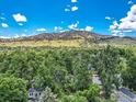 Scenic view of mountains and trees surrounding a charming home, showcasing natural beauty at 3135 11Th St, Boulder, CO 80304