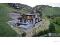 Aerial view of an elegant home with a private pool, outdoor lounge area, and beautifully landscaped grounds at 3645 Cholla Ct, Boulder, CO 80304