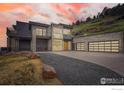Contemporary home with stone facade, modern garage doors and ample parking in a hillside community at 3645 Cholla Ct, Boulder, CO 80304