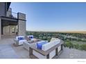 Outdoor patio area with a fireplace and seating that overlooks picturesque views at 3645 Cholla Ct, Boulder, CO 80304