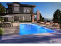 Stunning infinity pool with lounge chairs and an umbrella, overlooking a lush, green landscape at 3645 Cholla Ct, Boulder, CO 80304