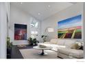 Bright living room with vaulted ceilings, large windows, art, and comfortable seating at 3865 Newport Ln, Boulder, CO 80304