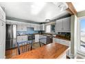 Modern kitchen with stainless steel appliances, eat-in bar, and stylish white cabinetry at 3885 Telluride Pl, Boulder, CO 80305
