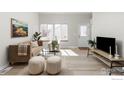 Sun-filled living room features sleek floors, neutral decor, and a welcoming ambiance at 390 Owl Dr, Louisville, CO 80027