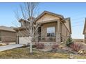 Charming single-Gathering house with covered porch, stone accents, and a well-maintained front lawn at 4420 White Rock Dr, Broomfield, CO 80023