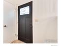 Close-up of the dark wood front door from the interior of the home, next to a white closet door at 4652 Hampshire St, Boulder, CO 80301
