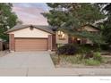Charming home with a brick and siding exterior, a well-maintained lawn, mature trees, and an attached garage at 4652 Hampshire St, Boulder, CO 80301