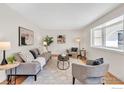 Bright living room featuring hardwood floors, stylish furniture, and a large window at 4825 Devonshire St, Boulder, CO 80301