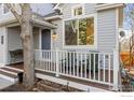 Cozy front porch with white railing, wood decking, and comfortable seating area at 554 W Spruce Way, Louisville, CO 80027