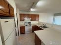 Efficient kitchen design with ample counter space, traditional cabinets, and standard appliances at 8044 Countryside Park # 220, Longmont, CO 80503