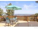 A spacious deck with an umbrella-covered dining set showcases breathtaking panoramic views at 82 Grove Ct, Boulder, CO 80302