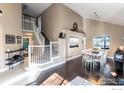 Open-concept living and dining area with high ceilings and hardwood floors at 92 Kolar Ct, Erie, CO 80516