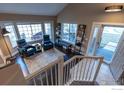 Bright sitting area with large windows, comfortable seating, and hardwood floors at 92 Kolar Ct, Erie, CO 80516