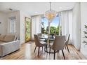 Bright dining room features a modern chandelier, hardwood floors, and plenty of light at 1221 Linden Ave, Boulder, CO 80304