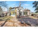 Spacious backyard featuring a stone patio, sunroom, and lush green lawn at 130 S 36Th St, Boulder, CO 80305