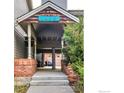 Building entrance featuring well-kept stairs, brickwork, and a covered entrance with building number at 1405 Broadway # 101, Boulder, CO 80302