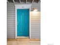 A stylish, bright blue front door with white trim and modern hardware welcomes you home at 1405 Broadway # 101, Boulder, CO 80302