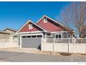 Exterior view showcasing the well-maintained garage and fenced yard of the property at 1451 Moonlight Dr, Longmont, CO 80504