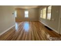 Spacious living room with gleaming hardwood floors and windows at 150 S Canosa Ct, Denver, CO 80219