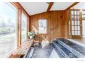 Bright entryway features tiled floors, wood paneling, bench, and stairs to another level at 1615 Kalmia Ave, Boulder, CO 80304