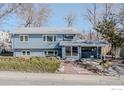 Charming two-story blue house with a covered carport and well-maintained landscaping at 1615 Kalmia Ave, Boulder, CO 80304