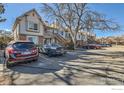 Exterior view of townhomes with parking lot featuring mature trees and available resident parking at 185 S Sable Blvd # 29, Aurora, CO 80012