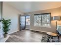 Living room with wood floors, plant, and a large window providing natural light at 185 S Sable Blvd # 29, Aurora, CO 80012