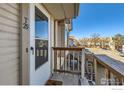 View of the porch with wood railings and a door at unit 29 of the property at 185 S Sable Blvd # 29, Aurora, CO 80012