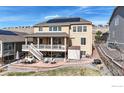 Large backyard patio, dining area, and stairs to second floor deck of this attractive two-story home at 18740 W 85Th Dr, Arvada, CO 80007