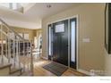 View of the front door, with sidelights, opening to the living room, and staircase nearby at 1919 Breen Ln, Superior, CO 80027