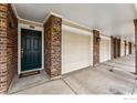 View of a townhouse showing brick accents and garage and entry doors, perfect for low-maintenance living at 2192 Eagle Ave, Superior, CO 80027