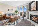 Bright living room featuring modern fireplace, beautiful rug, comfortable seating, and sliding glass doors to a balcony at 2192 Eagle Ave, Superior, CO 80027