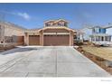 Home exterior showcasing a large driveway and three-car garage at 2236 Alpine Dr, Erie, CO 80516