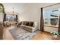 Cozy living room with ample seating, hardwood floors, and natural light from large windows at 2236 Alpine Dr, Erie, CO 80516