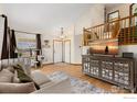 Inviting living room featuring wood floors, vaulted ceilings, staircase and natural light at 2236 Alpine Dr, Erie, CO 80516