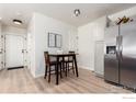 Cozy dining area located off the kitchen with stainless steel refrigerator at 2426 W 82Nd Pl # D, Westminster, CO 80031