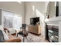 Bright living room featuring a fireplace, and a sliding glass door at 2426 W 82Nd Pl # D, Westminster, CO 80031