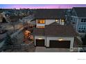 Wide aerial view of home showcasing backyard patio, well-kept landscaping and multi-car garage at 2811 Twin Lakes Cir, Lafayette, CO 80026