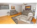 Spacious living room with hardwood floors and comfortable seating arrangement at 2996 S Lamar St, Denver, CO 80227